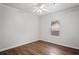 Bedroom with hardwood floors, white walls and trim, a ceiling fan with light and a window with blinds at 1001 Newton S Ave, St Petersburg, FL 33705