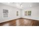 Bright bedroom featuring hardwood floors and three windows, creating a naturally lit interior at 1001 Newton S Ave, St Petersburg, FL 33705