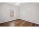 Bedroom with hardwood floors, white walls and trim, and a window with blinds at 1001 Newton S Ave, St Petersburg, FL 33705