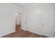Bedroom with hardwood floors, white walls and trim, and doorways leading to other rooms at 1001 Newton S Ave, St Petersburg, FL 33705