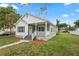 Inviting two-story home with an inviting porch, green lawn, and sidewalk leading to the front door at 1001 Newton S Ave, St Petersburg, FL 33705