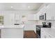 Modern kitchen features stainless steel appliances, quartz countertops, and a center island with bar seating at 1001 Newton S Ave, St Petersburg, FL 33705