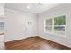 Bright living room showcasing hardwood floors, a door, and a well lit window at 1001 Newton S Ave, St Petersburg, FL 33705