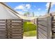 Well-maintained backyard accessible through a gated fence, featuring green grass and shaded area for enjoyment at 11092 Jenny Wren Rd, Weeki Wachee, FL 34614