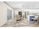 Open floor plan dining room featuring a round table, wood tile floors, and access to the kitchen at 11092 Jenny Wren Rd, Weeki Wachee, FL 34614