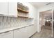 Bright white kitchen with marble countertops and decorative backsplash at 11200 102Nd N Ave # 19, Seminole, FL 33778