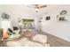 Inviting living room featuring bright decor, a ceiling fan, and an open layout to a sunroom with natural light at 11200 102Nd N Ave # 19, Seminole, FL 33778