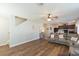 Bright living room featuring wood floors, ceiling fan, and open floor plan at 11914 Ledbury Commons Dr, Gibsonton, FL 33534