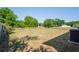 Large, grassy backyard featuring a chain-link fence and mature trees, offering privacy and space at 1225 Harvest Home Ct, Ruskin, FL 33570