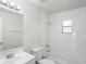 Bright bathroom with tiled shower-tub combination, modern vanity, and neutral color palette at 1225 Harvest Home Ct, Ruskin, FL 33570
