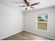 Bedroom with modern ceiling fan and window showcasing a suburban view at 1225 Harvest Home Ct, Ruskin, FL 33570