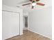 Bedroom features a ceiling fan, closet, wood flooring, and neutral color palette at 1225 Harvest Home Ct, Ruskin, FL 33570