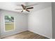 Bedroom with modern ceiling fan and window showcasing a suburban view at 1225 Harvest Home Ct, Ruskin, FL 33570