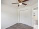 Bedroom features a ceiling fan, closet, wood flooring, and neutral color palette at 1225 Harvest Home Ct, Ruskin, FL 33570
