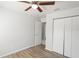 Bedroom features a ceiling fan, closet, wood flooring, and neutral color palette at 1225 Harvest Home Ct, Ruskin, FL 33570
