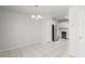 View of kitchen and dining area, with a stainless steel refrigerator, tile floors and modern lighting at 1225 Harvest Home Ct, Ruskin, FL 33570