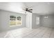 Bright living room with tile floors, a ceiling fan, and plenty of natural light from large windows at 1225 Harvest Home Ct, Ruskin, FL 33570
