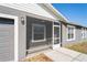 View of the screened porch area with tile flooring and access to the garage and the house at 1225 Harvest Home Ct, Ruskin, FL 33570