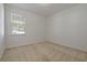 Bright bedroom features neutral carpet, a window with blinds, and white walls at 1225 Wild Daisy Dr, Plant City, FL 33563