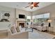 Inviting living room with a tiled fireplace, bright windows, and comfortable, neutral-toned furniture at 1231 Country Club N Rd, St Petersburg, FL 33710