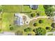 An overhead perspective of the property, showcasing its manicured yard and a winding driveway at 13206 Lewis Raulerson Road, Dover, FL 33527