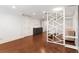 Spacious basement with hardwood floors, white accents and a decorative geometric screen at 13206 Lewis Raulerson Road, Dover, FL 33527