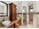 A luxurious bathroom features double sinks, wooden cabinets, and marble floors at 13206 Lewis Raulerson Road, Dover, FL 33527
