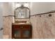 Charming powder room features a granite countertop, a decorative mirror, and warm, inviting tile work at 13206 Lewis Raulerson Road, Dover, FL 33527