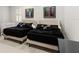 Cozy bedroom featuring two beds with black bedding, decorative pillows, and abstract art at 13206 Lewis Raulerson Road, Dover, FL 33527