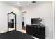 Well-lit bedroom with an ornate mirror, dark wood dresser, and TV, offering a luxurious feel at 13206 Lewis Raulerson Road, Dover, FL 33527