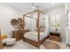 A well decorated bedroom featuring a four-poster bed and wood flooring at 13206 Lewis Raulerson Road, Dover, FL 33527