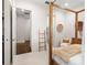 This bedroom has a four poster bed and provides access to the hallway at 13206 Lewis Raulerson Road, Dover, FL 33527
