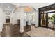Elegant dining room with chandelier, dark wood floors, and arched doorways at 13206 Lewis Raulerson Road, Dover, FL 33527