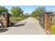 Gated driveway leading to a large home with manicured landscaping at 13206 Lewis Raulerson Road, Dover, FL 33527