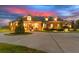 Beautiful sunset view of a home with manicured landscaping and circular driveway at 13206 Lewis Raulerson Road, Dover, FL 33527