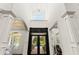 Grand foyer with high ceilings, chandelier, and wrought iron front doors at 13206 Lewis Raulerson Road, Dover, FL 33527
