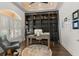Well-appointed home office featuring custom built-ins, a rolling ladder, and a large window, creating a functional workspace at 13206 Lewis Raulerson Road, Dover, FL 33527