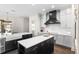 Bright and airy kitchen with white and gray cabinets, double islands, stainless steel appliances, and a pantry at 13206 Lewis Raulerson Road, Dover, FL 33527
