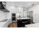 Well-equipped kitchen with white cabinetry, a black island, stainless steel appliances, and a built-in oven and microwave at 13206 Lewis Raulerson Road, Dover, FL 33527