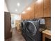 Efficient laundry room with extensive storage, stylish counter tops, and modern appliances at 13206 Lewis Raulerson Road, Dover, FL 33527