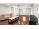 Spacious room with sleek wood floors, stylish furnishings, and ample lighting creates a comfortable retreat at 13206 Lewis Raulerson Road, Dover, FL 33527