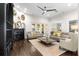 Open living room with a fireplace, a ceiling fan, sliding doors to the outside, and neutral tones, creating a seamless indoor-outdoor flow at 13206 Lewis Raulerson Road, Dover, FL 33527