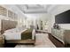 A spacious main bedroom featuring wood floors, tray ceilings, and glass doors to the outside at 13206 Lewis Raulerson Road, Dover, FL 33527