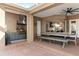 Outdoor kitchen and dining area with a stainless steel grill and charming design features at 13206 Lewis Raulerson Road, Dover, FL 33527