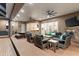 Expansive covered patio with outdoor seating, fireplace, and kitchen area for entertaining at 13206 Lewis Raulerson Road, Dover, FL 33527