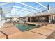 Large screened in pool with slide, pool furniture and brick surround at 13206 Lewis Raulerson Road, Dover, FL 33527