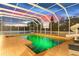 Large screened in pool with slide, pool furniture and brick surround at 13206 Lewis Raulerson Road, Dover, FL 33527
