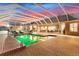 Large screened in pool with slide, pool furniture and brick surround with the home in the background at 13206 Lewis Raulerson Road, Dover, FL 33527