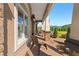 Covered front porch area of a home with stone columns and brick floor at 13206 Lewis Raulerson Road, Dover, FL 33527