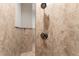 Modern tiled shower features dual shower heads and neutral stone tile for a relaxing bathing experience at 13206 Lewis Raulerson Road, Dover, FL 33527